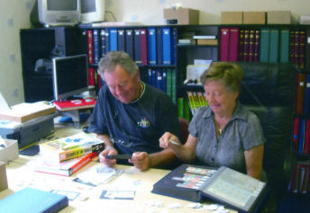 John and Joan Dixon sorting stamps